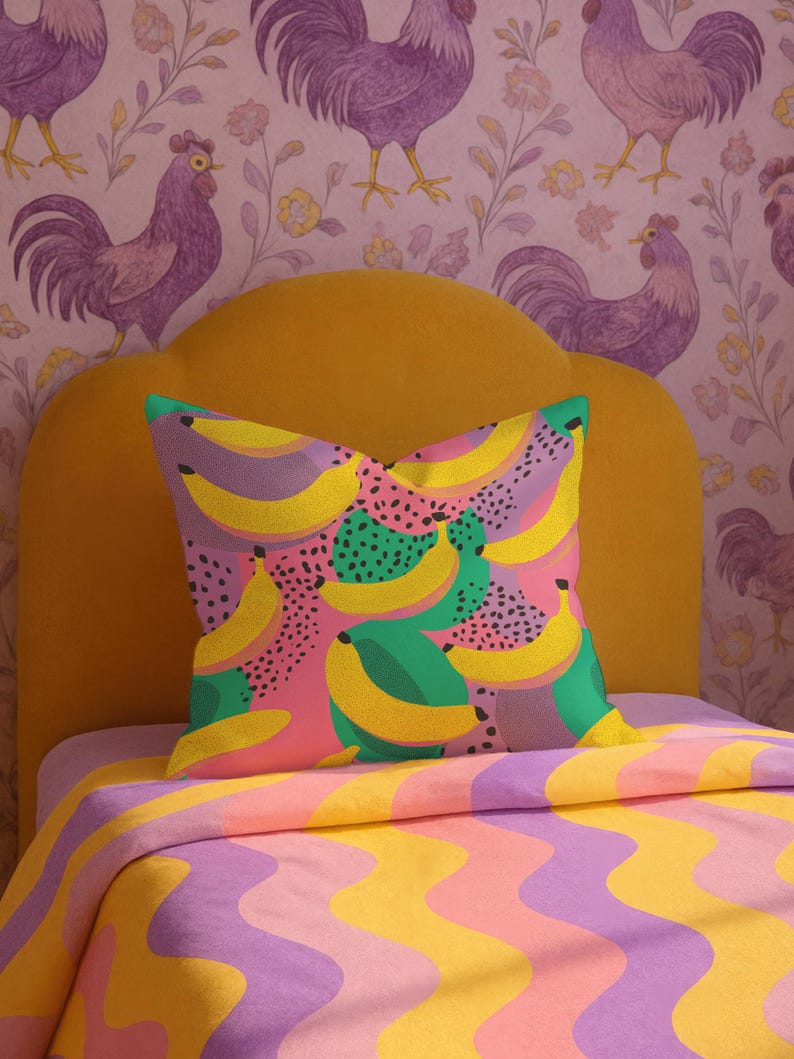 Square pillowcase featuring a bold and playful banana print in a vibrant pop art style. The design includes bright yellow bananas layered over a backdrop of pink, purple, green, and teal with dotted and speckled textures for a dynamic, retro-inspired look. Made of smooth fabric with crisp edges and a snug fit, the pillowcase showcases a saturated, high-contrast palette perfect for maximalist or dopamine decor. Pillow cover only; insert not included.
