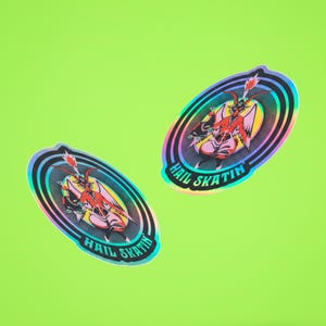 Vibrant 'Hail Skatin'' sticker featuring a colorful goat demon with roller skates, embodying a quirky mix of satanic and skate culture. Perfect for adding some edgy flair to your belongings.