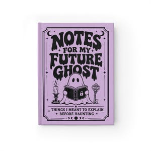 A 5 by 7 inch hardcover journal with a matte pastel purple cover and black printed graphics. The front features a retro inspired illustration of a white ghost character. One design shows the ghost holding a locked book flanked by a lit candle and a skeleton key with text reading Notes For My Future Ghost. The other shows the ghost peeking over a blank label with text reading Property Of The Future Ghost. Both include crescent moons, four point stars, and vintage decorative border frames.