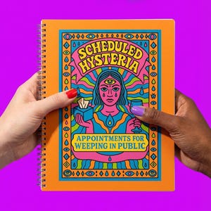 May include: Orange spiral-bound notebook with the words "SCHEDULED HYSTERIA" and "APPOINTMENTS FOR WEEPING IN PUBLIC" in a colorful, psychedelic design. The cover art features a woman with a third eye, tears, and holding a tissue and a glass.