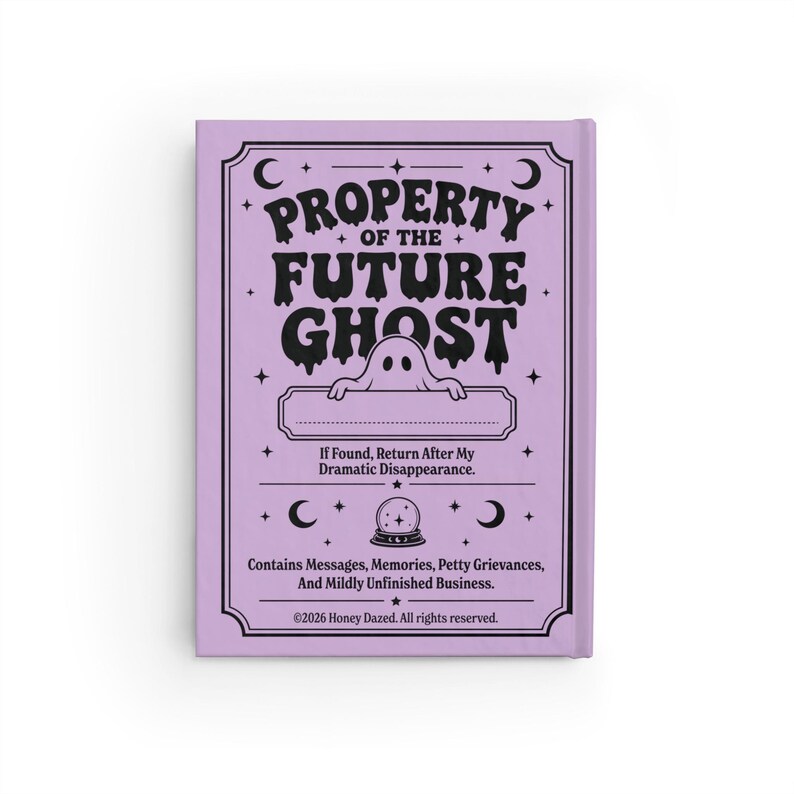 A 5 by 7 inch hardcover journal with a matte pastel purple cover and black printed graphics. The front features a retro inspired illustration of a white ghost character. One design shows the ghost holding a locked book flanked by a lit candle and a skeleton key with text reading Notes For My Future Ghost. The other shows the ghost peeking over a blank label with text reading Property Of The Future Ghost. Both include crescent moons, four point stars, and vintage decorative border frames.