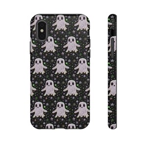Black phone case featuring white textured ghost pattern with multicolored star accents. Kawaii-style ghosts with simple black eyes on dark background.