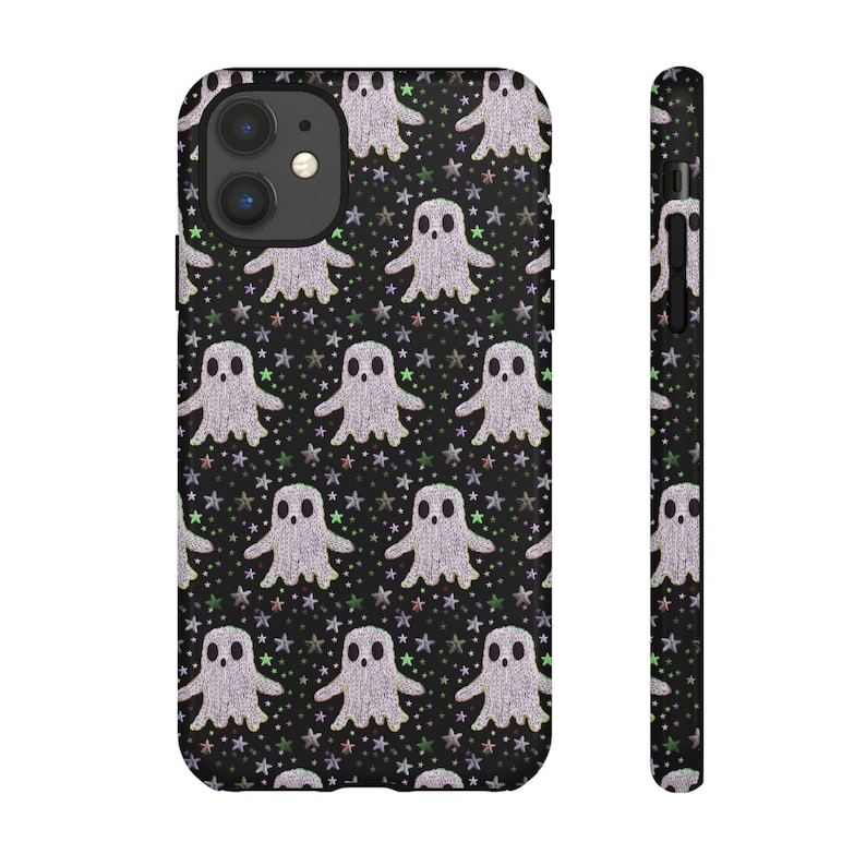 Black phone case featuring white textured ghost pattern with multicolored star accents. Kawaii-style ghosts with simple black eyes on dark background.