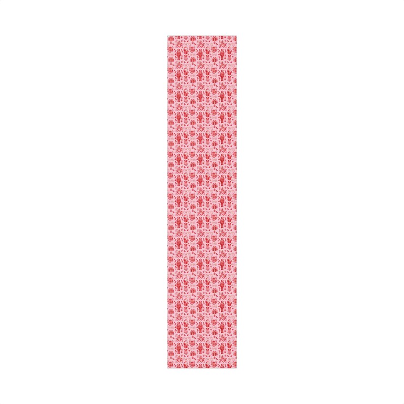 Premium satin finish wrapping paper featuring a repeating pastel goth pattern on a pink background. The design showcases a playful yet spooky aesthetic with high-contrast skeleton nutcrackers, skull jack-in-the-boxes, and rocking horse skeletons in soft pinks, and reds. The paper texture appears semi-glossy. Shown in three available sizes including sheets and rolls, specifically 29 inches wide, suitable for wrapping gifts for holidays, birthdays, or gothic themed occasions.