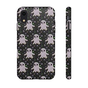 Black phone case featuring white textured ghost pattern with multicolored star accents. Kawaii-style ghosts with simple black eyes on dark background.