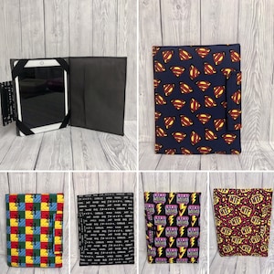 May include: A collage of ten different fabric designs for tablet cases. The designs include a Superman logo pattern, a geometric pattern of squares in red, yellow, and blue, a pattern of lightning bolts and the words "Stay Weird", a pattern of the words "Stay Weird" in a rainbow of colours, a pattern of the words "Stay Weird" in black and white, a pattern of the words "Stay Weird" in pink and yellow, a pattern of the words "Stay Weird" in blue and yellow, a pattern of the words "Stay Weird" in green and yellow, a pattern of the words "Stay Weird" in orange and yellow, and a pattern of the words "Stay Weird" in purple and yellow.
