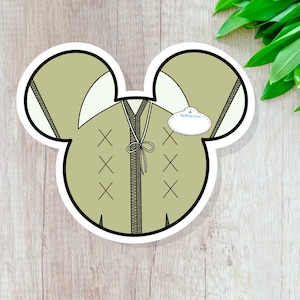 May include: A green Mickey Mouse-shaped sticker with a brown zipper and a name tag that says "Walt Disney World".