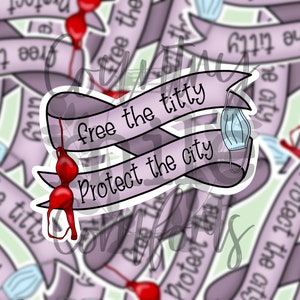 Può includere: Un adesivo viola e bianco con il testo "Free the titty Protect the city" in stile banner. L'adesivo presenta un reggiseno rosso e una maschera facciale blu.