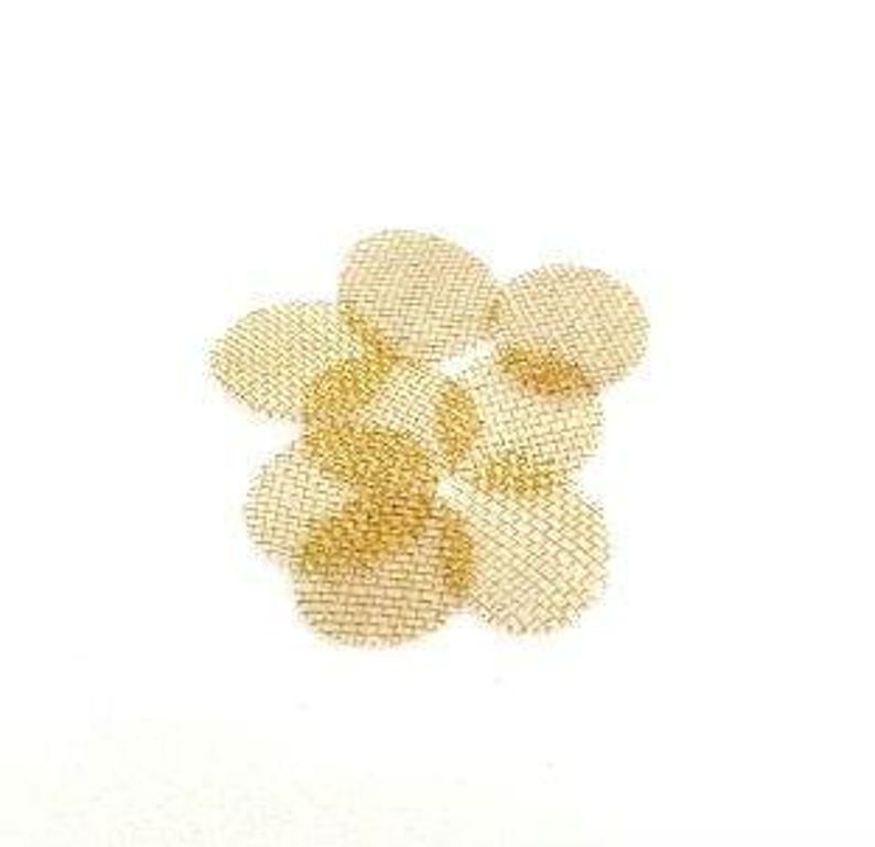 May include: A cluster of small, round, gold-colored metal mesh screens. The screens are arranged in a slightly overlapping pattern against a plain white background. The mesh appears to be finely woven.