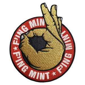 May include: Red, white, and gold embroidered patch with a hand making the "OK" sign and the text "FING MINT FING MINT" around the hand.