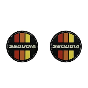 May include: Two black round patches with white stitching. Each patch has a red, orange, and yellow striped design and the word "SEQUOIA" in white letters.