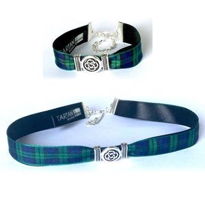 May include: A black choker necklace with a green and blue tartan ribbon and a silver Celtic knot charm. The ribbon has the word "Tartan" printed on it.