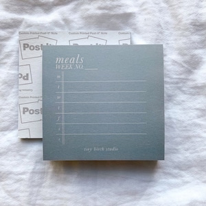 May include: A blue notepad with the text "meals WEEK NO." and lined paper. The notepad has the text "tiny birch studio" at the bottom.