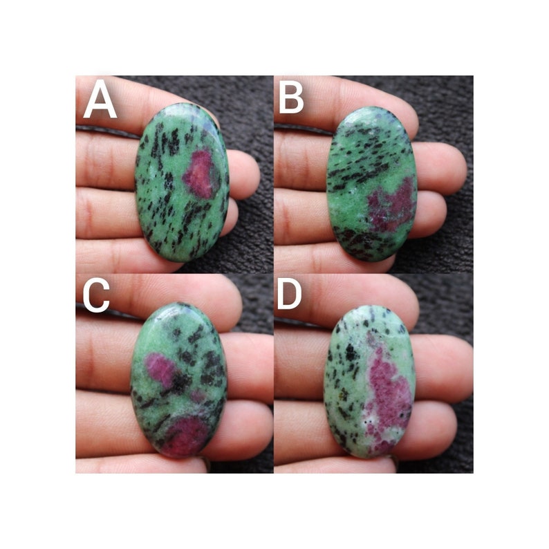 May include: Four oval-shaped green gemstones with black and pink markings. The gemstones are labeled A, B, C, and D.