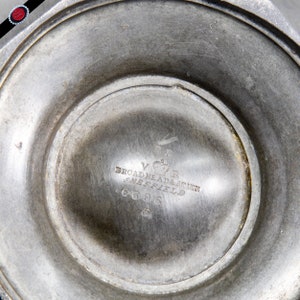 May include: Close-up of the bottom of a silver pitcher with the inscription "V.R. Broadhead & Atkinson Sheffield 6696"