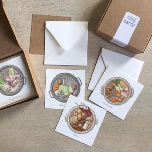 May include: A set of mini cards with illustrations of Japanese hot pot dishes, such as tonyunabe, shabu, chankonabe, and oden. The cards are square, with white envelopes and a brown box labelled "mini cards".
