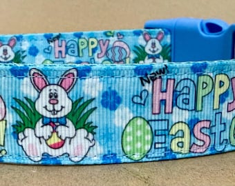 May include: Blue dog collar with a white background and a repeating pattern of bunnies, eggs, and the text "Happy Easter!"