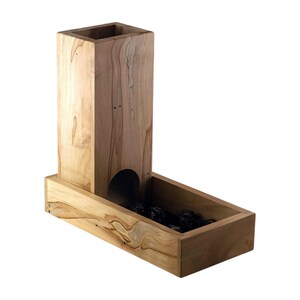 May include: A wooden dice tower and tray set. The tower is rectangular with a square opening at the top and a curved opening near the bottom. The tray is rectangular and holds several dark-coloured dice. The wood has a light brown colour with visible grain.