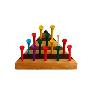 May include: A triangular wooden game board with 12 colorful golf tees arranged in a pyramid shape. The tees are red, yellow, blue, green, purple, and white.