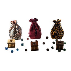 May include: Three drawstring dice bags in different patterns and colors. One bag is burgundy with a dragon design, another is black with gold dragons, and the third is white with blue and red dragons. Wooden dice boxes and various dice are also present.