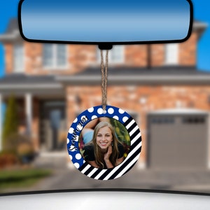 May include: A round car air freshener with a blue and white polka dot pattern and black and white stripes. The air freshener has a photo of a young woman in the center and the text "Senior 2021".