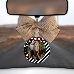 May include: A red and white polka dot and black and white striped car air freshener with a photo of a young woman and the text "Senior 2021".