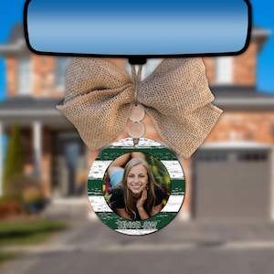 May include: A round car air freshener with a white and green striped design. A photo of a young woman is in the center of the air freshener. The text "Senior 2022" is printed on the bottom of the air freshener.