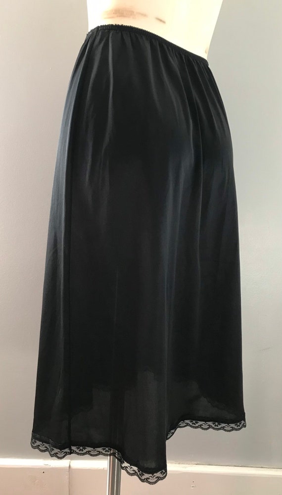 1980s Warners Full Skirt Black Slip with Lace Hem 