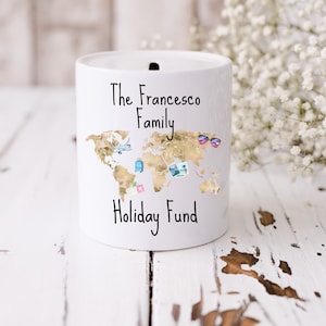 May include: White ceramic money box with a gold world map design and the text "The Francesco Family Holiday Fund".