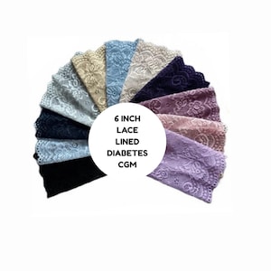 May include: A selection of 15 cm lace-lined CGM covers in a range of colours, such as black, blue, and lavender. The covers are displayed in a fan arrangement, highlighting the detailed lace designs.