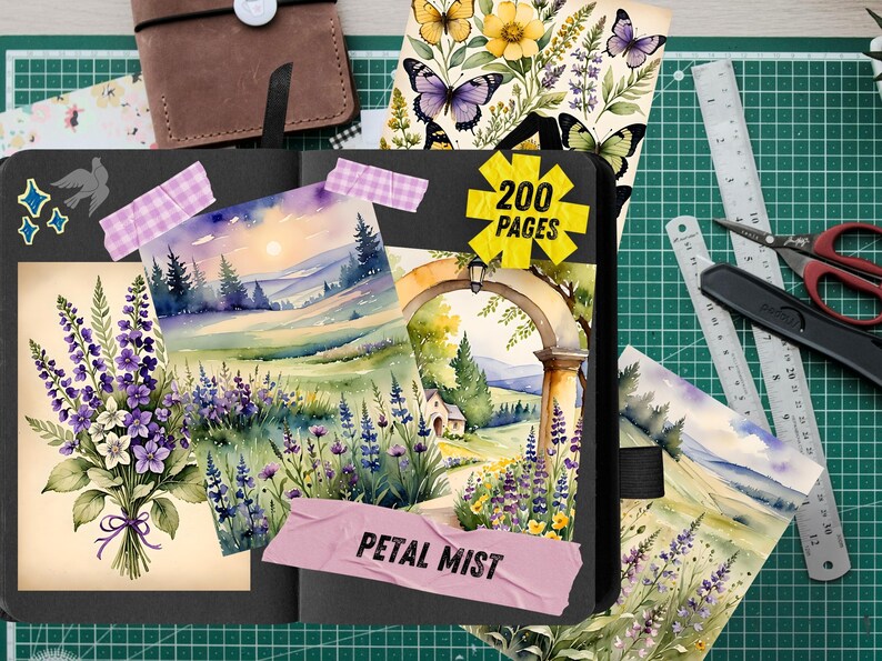 May include: An open black journal with watercolor illustrations of lavender, landscapes, and butterflies. The journal has a sticker that says "200 pages" and a pink label that says "Petal Mist". A brown leather notebook and stationery are in the background.