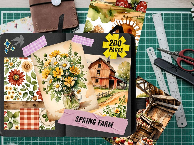 May include: A black journal with watercolor illustrations of a farm scene, sunflowers, and daisies. The journal has 200 pages and includes decorative stickers and washi tape. A brown leather notebook and cutting tools are also visible.