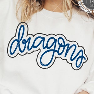 May include: A white sweatshirt with the word "dragons" written in blue cursive lettering with a black outline.