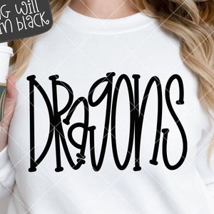 May include: White sweatshirt with the word "DRAGONS" written in black, outlined, cursive lettering. The text is centered on the shirt. The image is on a white background with a checkered pattern.