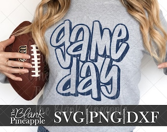 May include: A gray sweatshirt with the text "Game Day" in blue outlined letters. The text is in a bold, playful font.