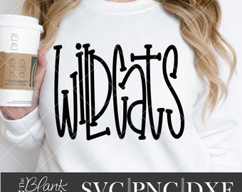 May include: A white sweatshirt with the word "WILDCATS" written in black, stylized lettering. The sweatshirt is being held by a person.