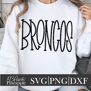 May include: White sweatshirt with the word "BRONGOS" in black outlined letters.