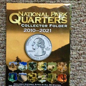 May include: A collector folder for National Park Quarters from 2010-2021. The cover features a quarter coin with the words "Liberty" and "Quarter Dollar." It includes historic sites in all 50 states, the District of Columbia, and U.S. territories.