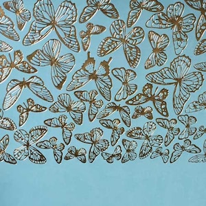 May include: A blue background with a pattern of gold butterflies. The butterflies are arranged in a random pattern and are all facing different directions.