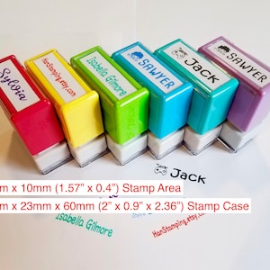 May include: Six rectangular self-inking stamps in red, yellow, green, blue, teal, and purple. Each stamp features a custom name or text label on top. The stamp area is 1.57 inches by 0.4 inches, and the stamp case is 2 inches by 0.9 inches by 2.36 inches.