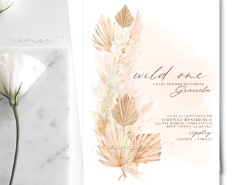 Könnte beinhalten: Eine Babyparty-Einladung mit einem Aquarelldesign. Die Einladung enthält den Text "wild one" und "A BABY SHOWER HONORING Gracela". Das Design umfasst beige und hellbraune getrocknete Blumen und Blätter. Die Einladung enthält auch Datum, Uhrzeit, Ort und RSVP-Informationen.