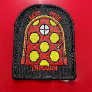 May include: Black embroidered patch with a red and yellow door with the text "Let's Peep Through"