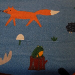 Flannel fabric woodland animals.  POP!  100% cotton.      Sold by the yard, 42 inches wide.