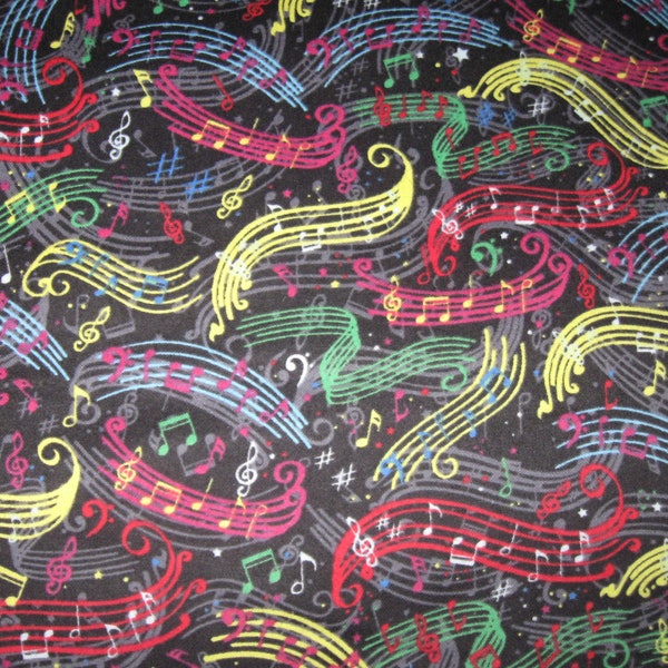 Flannel fabric music notes on black, colorful, 100% cotton.  Thirty-five inches long, 42 inches wide.  New not washed.