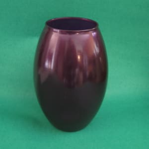 Purple amethyst glass vase. Flowerpot.  Round shape, 7 7/8 inches tall, 5 inch wide middle and an opening of 3 inches.  Indiana Glass Co.