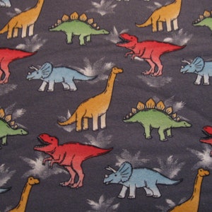 Flannel fabric dinosaurs bright on gray flannel 100% cotton. New, not washed. Sold by the yard, 42 inches wide.