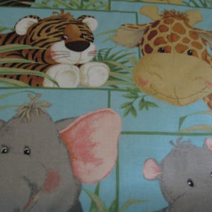 May include: A fabric pattern featuring cartoon animals on a light blue background. The design includes a tiger, giraffe, elephant, and hippo, with green foliage accents. The animals have soft, plush appearances, suitable for children's products.