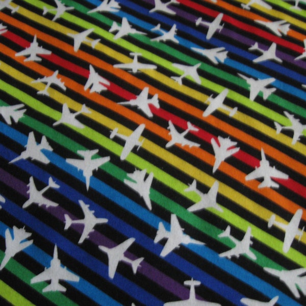 Flannel fabric airplanes, white planes, on rainbow stripes. 100% cotton. Sold by the yard. Two cuts.