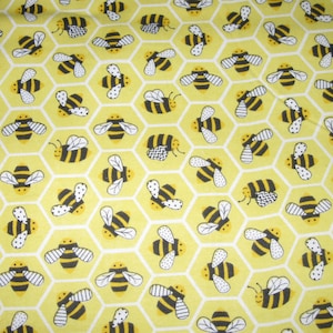 Flannel fabric bees, honeycomb yellow 100% cotton material. New not washed.  Sold by the yard.  Two pieces.