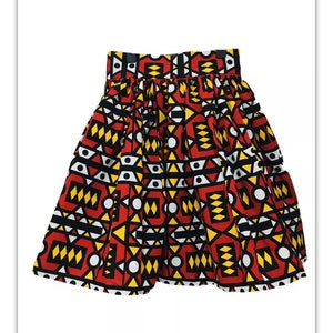 May include: A red, yellow, black and white patterned skirt with a gathered waist.